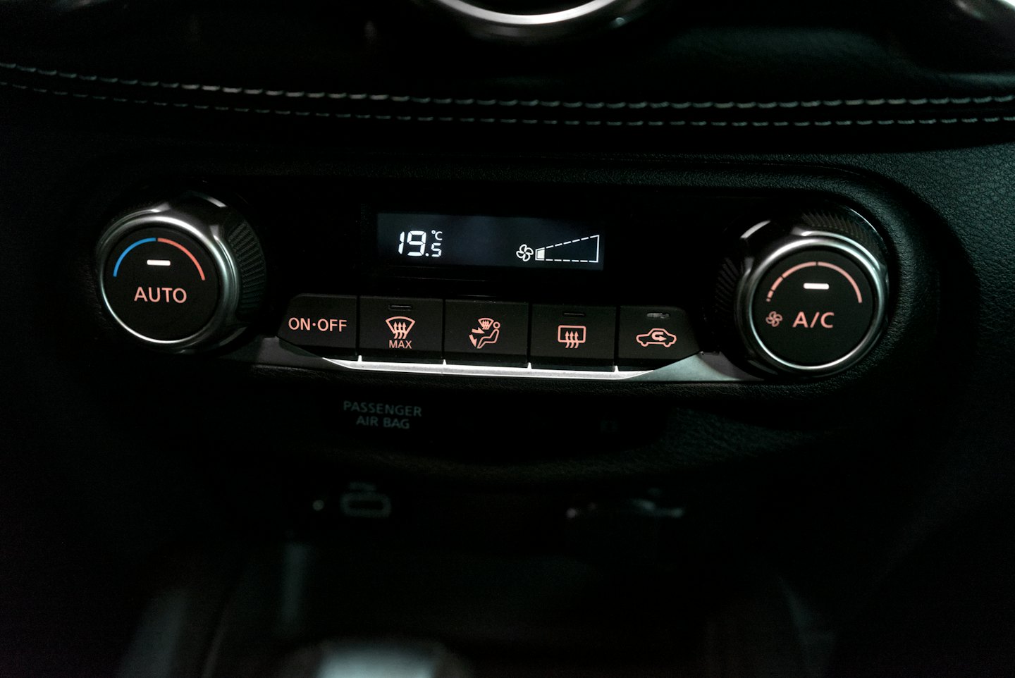 Car climate control panel displaying nineteen point five degrees Celsius.
